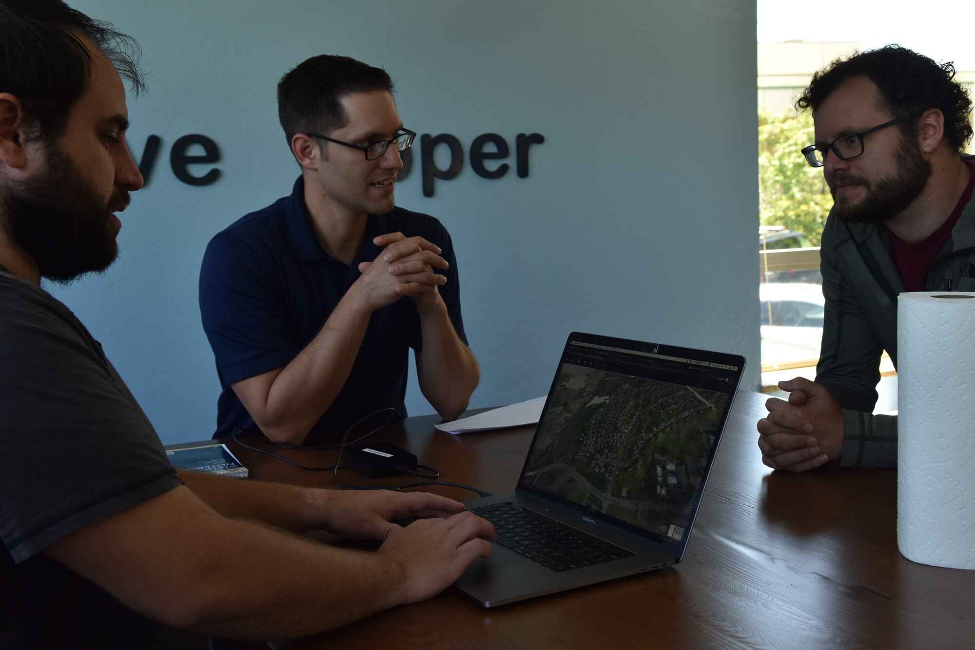 Will Urbina, Hivemapper head of flight operations, meets with Master Sgt. Nathaniel May, 9th Intelligence Squadron operations superintendent, and Dane Perry, Hivemapper product head, at the software company in San Francisco, California, June 4, 2019. Beale members have been partnering with the Hivemapper team since late 2018, to utilize the program as a way to same time, money, and manpower, while improving security capabilities.  (U.S. Air Force photo by Tech. Sgt. Veronica Montes)