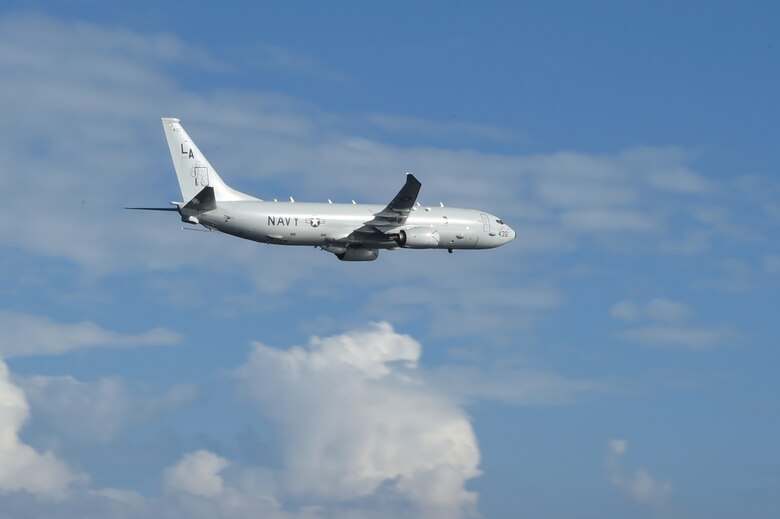 PHILIPPINE SEA (Sept. 26, 2014) A P-8A Poseidon from Patrol Squadron Five (VP-5) flies by the amphibious assault ship USS Peleliu (LHA 5) during a routine exercise in the Philippine Sea.