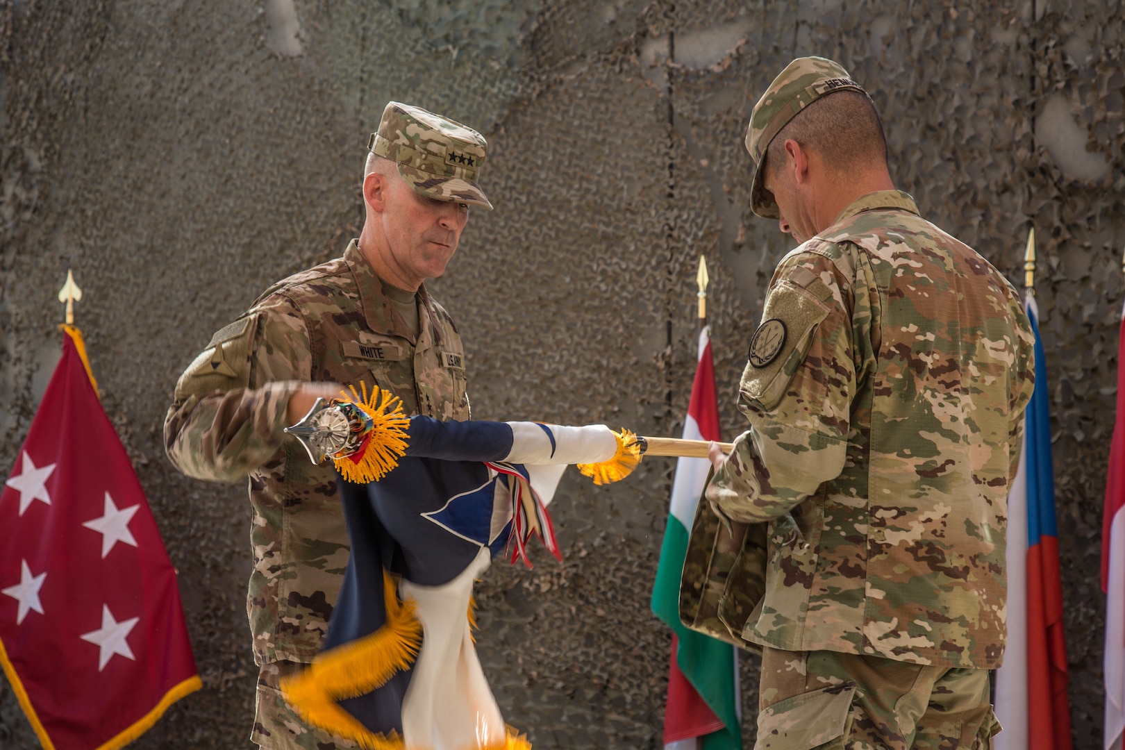 U.S. Army Lt. Gen. Robert White, commanding general of III Armored Corps, and Command Sgt. Maj. Daniel Hendrex, command sergeant major of III Armored Corps, uncase the III Armored Corps colors at the Combined Joint Task Force – Operation Inherent Resolve transfer of authority ceremony in Baghdad, Iraq, Sept. 14, 2019. The U.S. Army’s XVIII Airborne Corps, deployed from Fort Bragg, North Carolina to areas in Southwest Asia, transferred its command authority to the III Armored Corps, deployed from Fort Hood, Texas. CJTF-OIR is a 81-member global coalition, which works by, with, and through partner forces to defeat ISIS in designated areas of Iraq and Syria, and sets conditions for follow-on operations to increase regional stability.