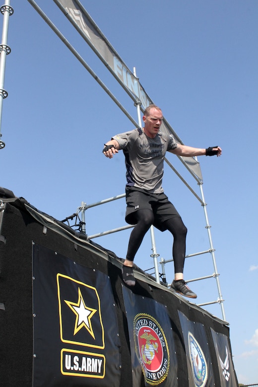 U.S. Navy Commander Timothy White jumps to the finish line at the end of his heat of the 2019 Alpha Warrior Inter-Service Battle Sept. 14, 2019, at Retama Park, Selma, Texas. Winning the team event for the second consecutive year was the U.S. Air Force, followed by the U.S. Army. (U.S. Air Force photo by Debbie Aragon)