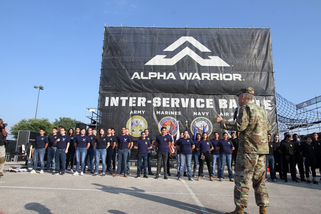 AFIMSC Commander Maj. Gen. Tom Wilcox talks to new recruits for the Air Force, Navy and Army about the importance of the oath of enlistment during the opening ceremonies of the 2019 Alpha Warrior Inter-Service Battle Sept. 14, 2019, at Retama Park, Selma, Texas. Following his remarks, the general administered the oath to the new Airmen. Senior leaders for the U.S. Navy and U.S. Army then did the same for their respective new recruits. (U.S. Air Force photo by Annette Strapple)