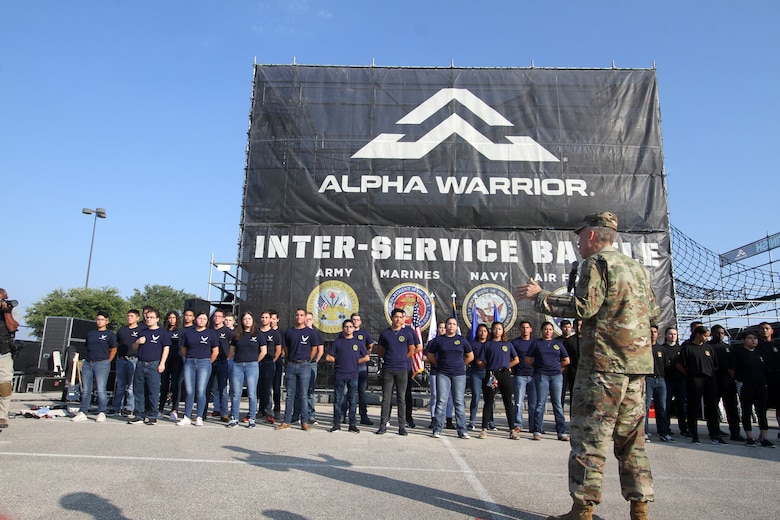 AFIMSC Commander Maj. Gen. Tom Wilcox talks to new recruits for the Air Force, Navy and Army about the importance of the oath of enlistment during the opening ceremonies of the 2019 Alpha Warrior Inter-Service Battle Sept. 14, 2019, at Retama Park, Selma, Texas. Following his remarks, the general administered the oath to the new Airmen. Senior leaders for the U.S. Navy and U.S. Army then did the same for their respective new recruits. (U.S. Air Force photo by Annette Strapple)