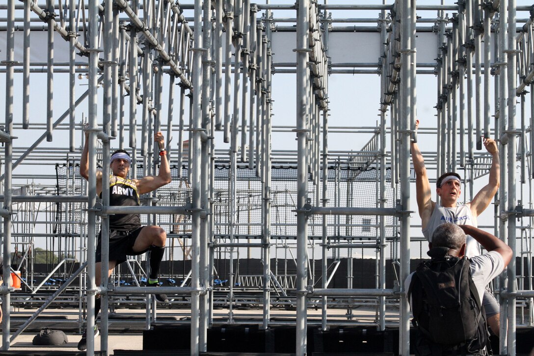 From left, brothers U.S. Army Lt. Col. Eric Palicia and U.S. Air Force Capt. Noah Palicia go head-to-head on the pipe bomb obstacle during the 2019 Alpha Warrior Inter-Service Battle Sept. 14, 2019, at Retama Park, Selma, Texas. Noah led his Air Force team to victory over the U.S. Army and U.S. Navy for the second year. The brothers had the fastest times finishing the course with Noah at 21 minutes, 5 seconds, and his brother at 22 minutes, 9 seconds. (U.S. Air Force photo by Debbie Aragon)