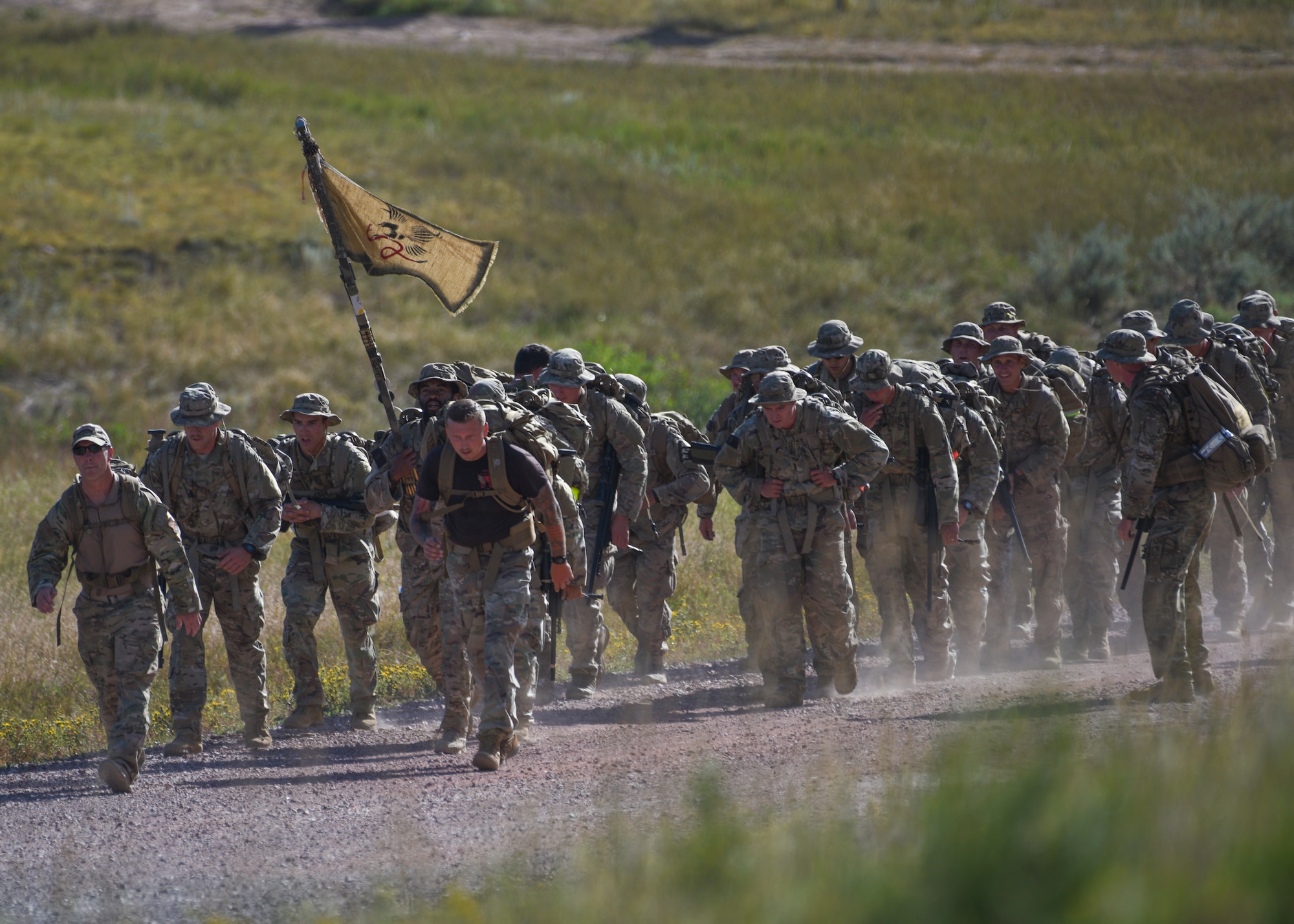 Students and instructors of the Nuclear Advanced Designated Marksman course ruck in formation at Camp Guernsey, Wyo., Sept. 29, 2019. The ruck applied stress to the students before their final-shot test, tiring out their muscles and nerves to create a realistic scenario they could face on the battlefield. (U.S. Air Force photo by Staff Sgt. Ashley N. Sokolov)