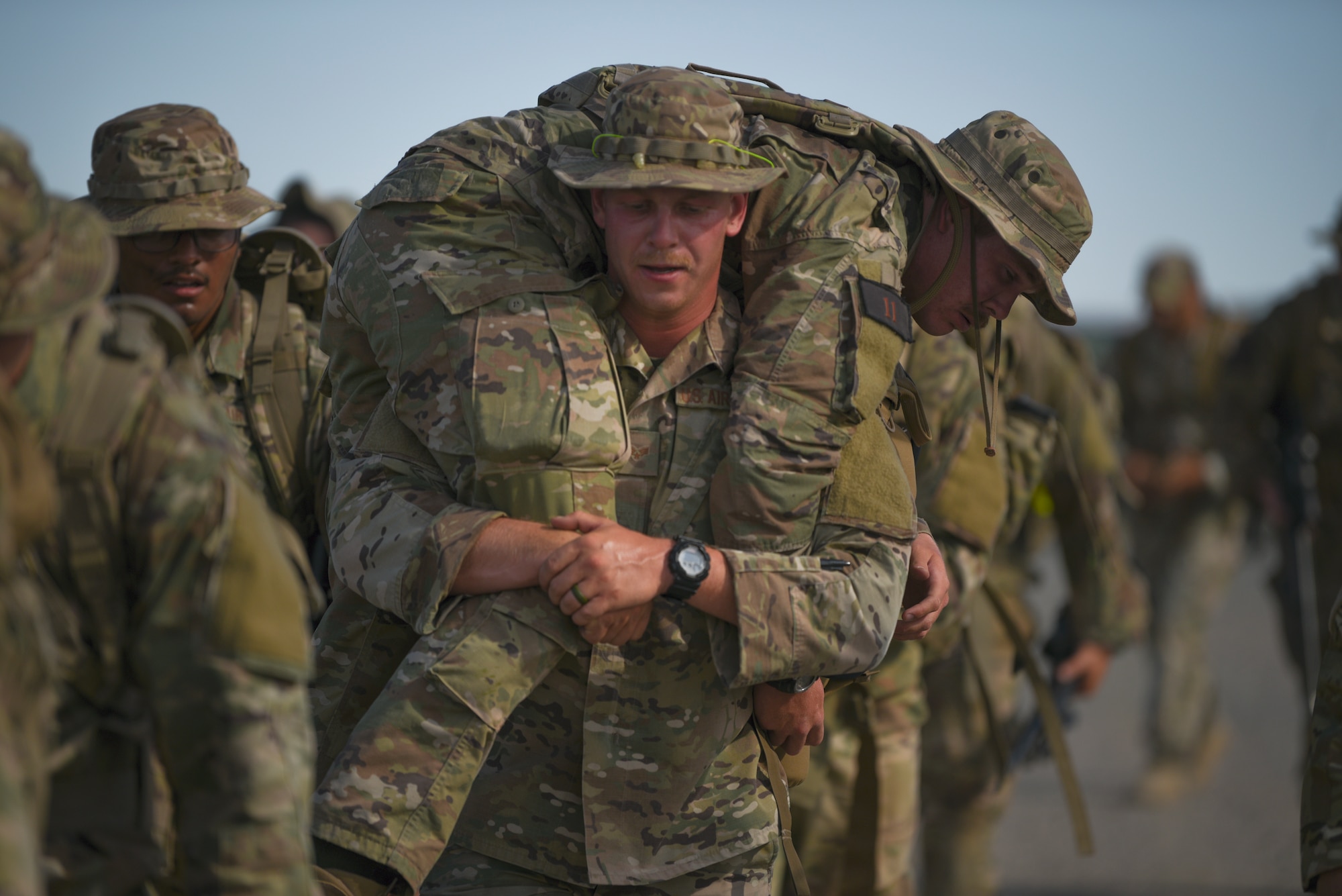 Senior Airman Daniel Pierce, 90th Ground Combat Training Squadron training instructor, carries Senior Airmen Dakota Cornett, 341st Security Support Squadron tactical response force member, while rucking at the Nuclear Advanced Designated Marksman course, at Camp Guernsey, Wyo., Sept. 29, 2019. During the ruck they simulated casualties to see how members would adapt to reach their objective. (U.S. Air Force photo by Staff Sgt. Ashley N. Sokolov)