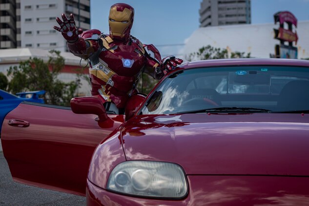 A car show attendee dressed as popular superhero, Iron Man, poses for a photo during the 2nd annual United Service Organizations Okinawa car show on Camp Foster, Okinawa, Japan, September 14, 2019. The car show helped strengthen relationships between local residents and members of the U.S. community through a public automobile exhibition.