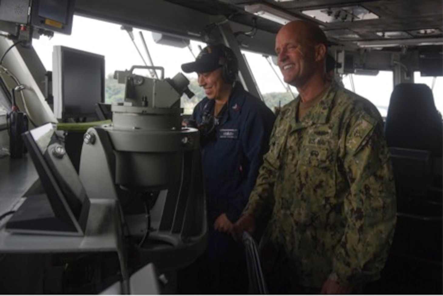PHILIPPINE SEA (September 14, 2019) Vice Adm. William R. Merz, Commander, 7th Fleet, speaks with a Sailor on the navigation bridge while touring the Navy’s forward-deployed aircraft carrier USS Ronald Reagan (CVN 76). USS Ronald Reagan, the flagship of Carrier Strike Group 5, provides a combat-ready force that protects and defends the collective maritime interests of its allies and partners in the Indo-Asia-Pacific region.