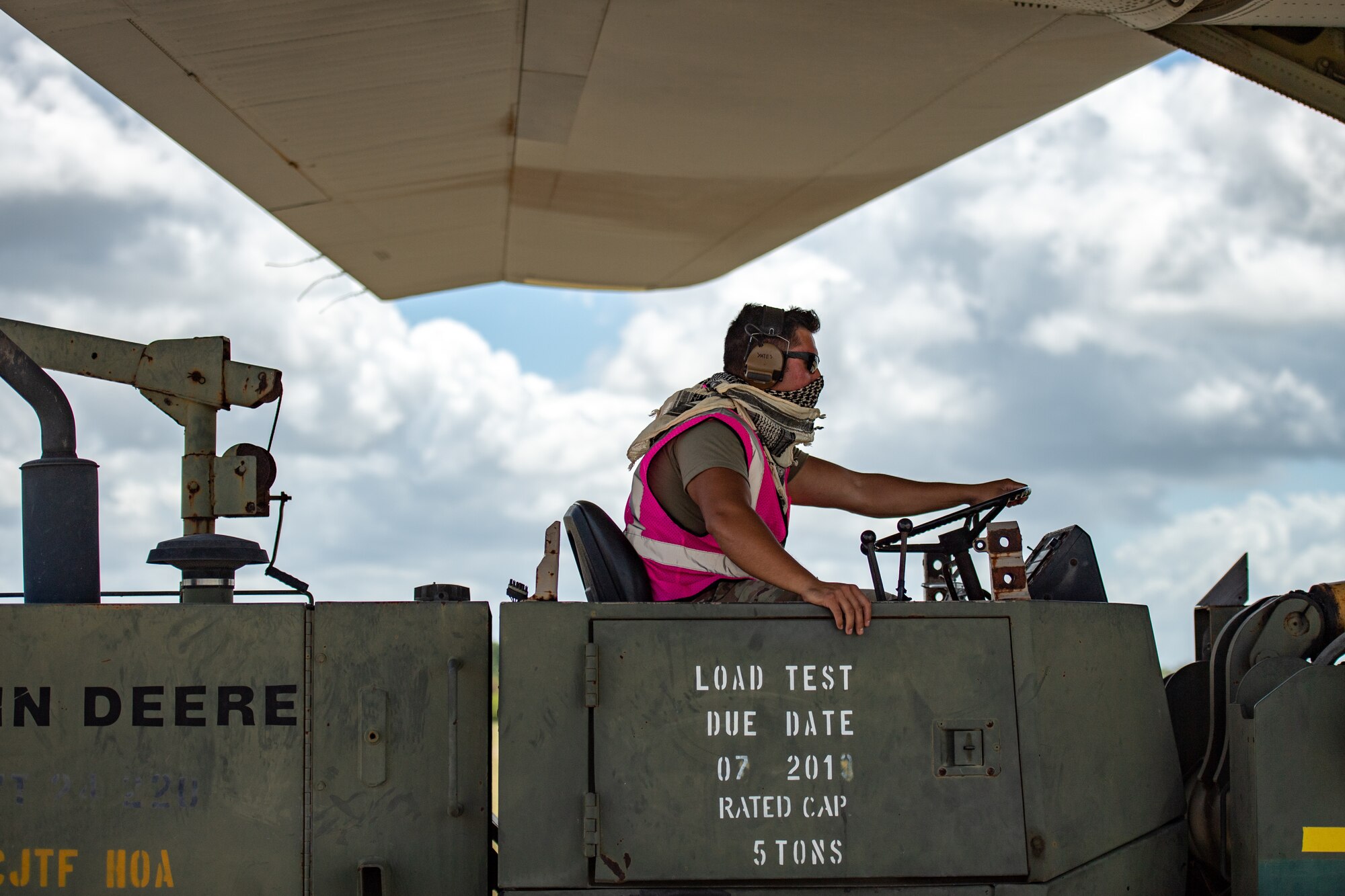 U.S. Air Force Tech. Sgt. Gary Yates, 475th Expeditionary Air Base Squadron air operations noncommissioned officer in charge, downloads cargo at Camp Simba, Kenya, Aug. 26, 2019. Yates worked with the 75th Expeditionary Airlift Squadron aircrew who delivered the cargo to Camp Simba. (U.S. Air Force photo by Staff Sgt. Devin Boyer)