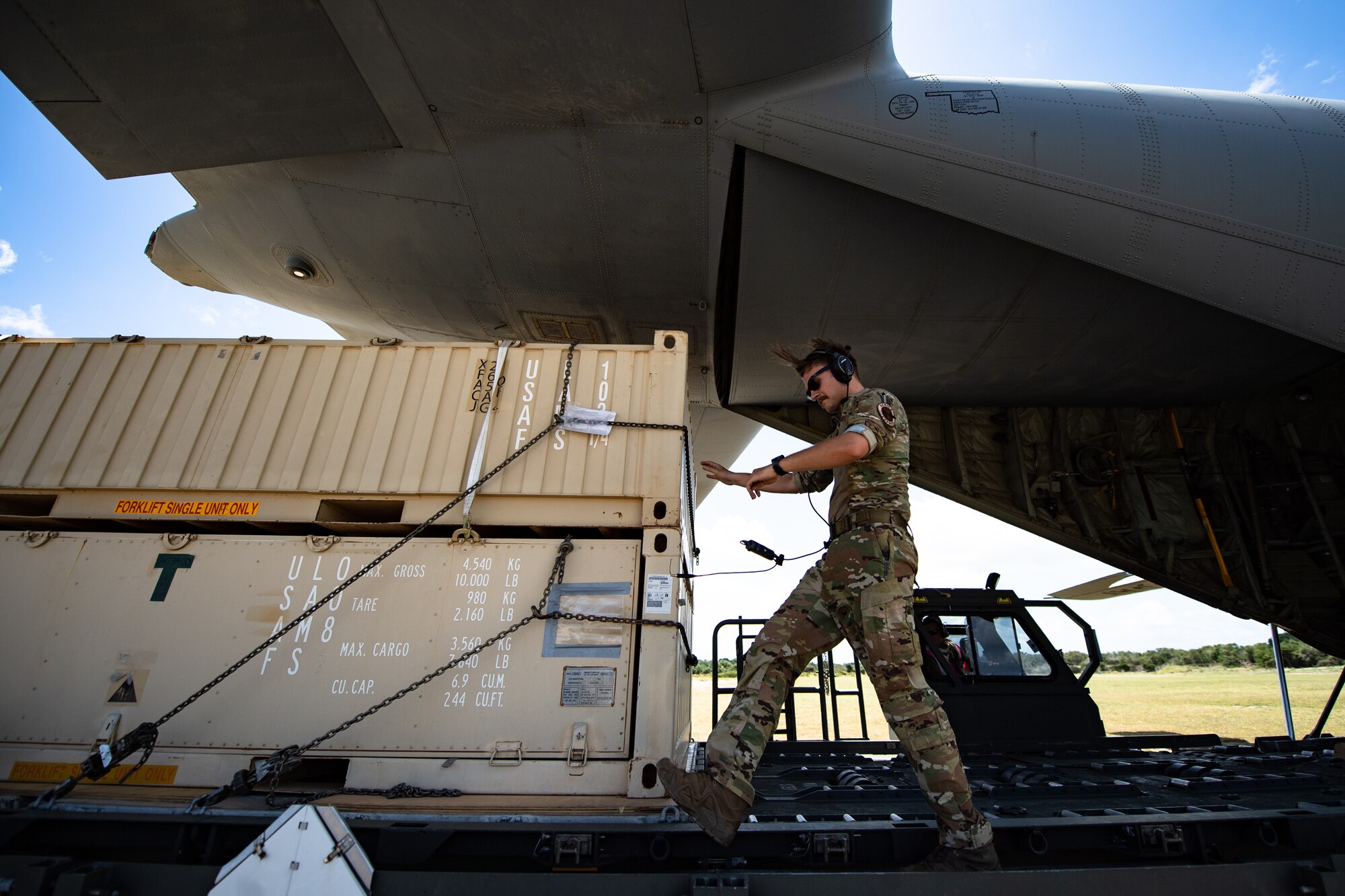 U.S. Air Force Staff Sgt. Alek Gorohoff, 75th Expeditionary Airlift Squadron instructor loadmaster, downloads cargo at Camp Simba, Kenya, Aug. 26, 2019. The 75th EAS provided airlift while the 475th Expeditionary Air Base Squadron operated vehicles to download the cargo. (U.S. Air Force photo by Staff Sgt. Devin Boyer)