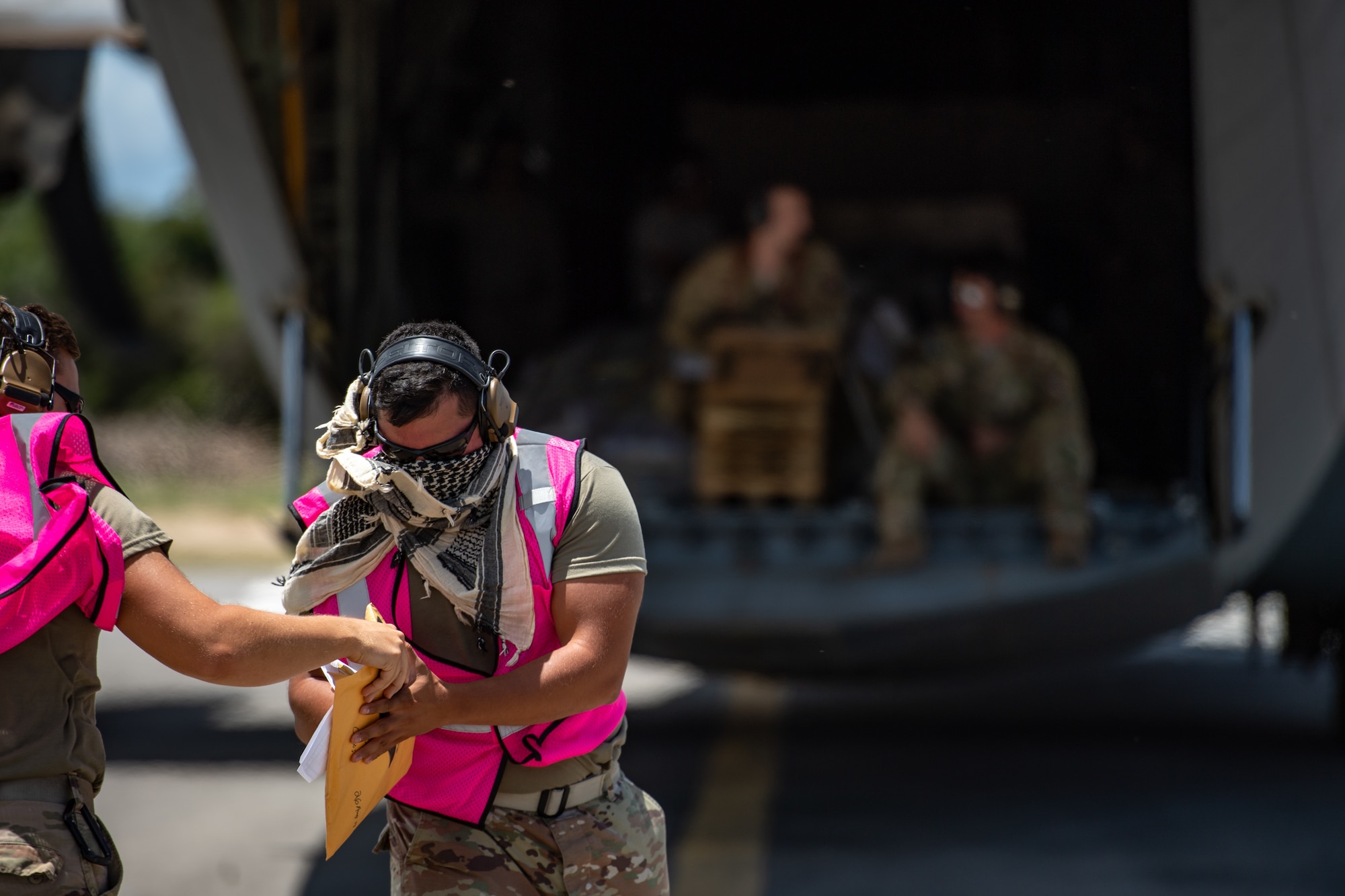 U.S. Air Force Tech. Sgt. Gary Yates, 475th Expeditionary Air Base Squadron air operations noncommissioned officer in charge, handles paperwork for an incoming shipment at Camp Simba, Kenya, Aug. 26, 2019. The 75th Expeditionary Airlift Squadron from Camp Lemonnier, Djibouti, delivered the cargo. (U.S. Air Force photo by Staff Sgt. Devin Boyer)