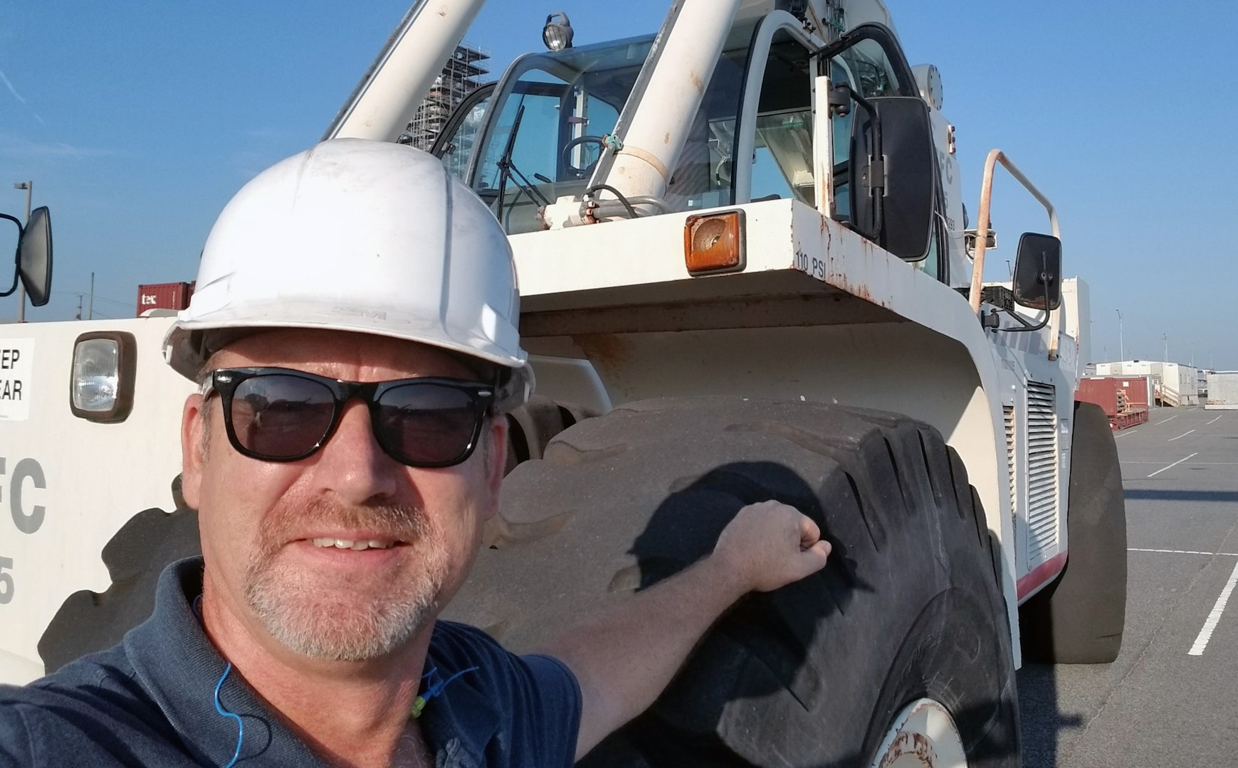 Ben Stoline, a forklift mechanic for DLA Distribution Norfolk, Virginia, remembers Hurricane Isabel’s blow to his home and community 16 years later. Ben leans against a forklift.