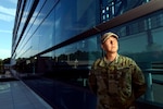 Army Staff Sgt. William Eisenhart, the explosive ordnance disposal operations noncommissioned officer in charge with the Army National Guard's operations directorate, stands in front of the Herbert R. Temple Jr. Army National Guard Readiness Center, Arlington Hall Station, Aug. 19, 2019.