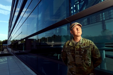 Army Staff Sgt. William Eisenhart, the explosive ordnance disposal operations noncommissioned officer in charge with the Army National Guard's operations directorate, stands in front of the Herbert R. Temple Jr. Army National Guard Readiness Center, Arlington Hall Station, Aug. 19, 2019.