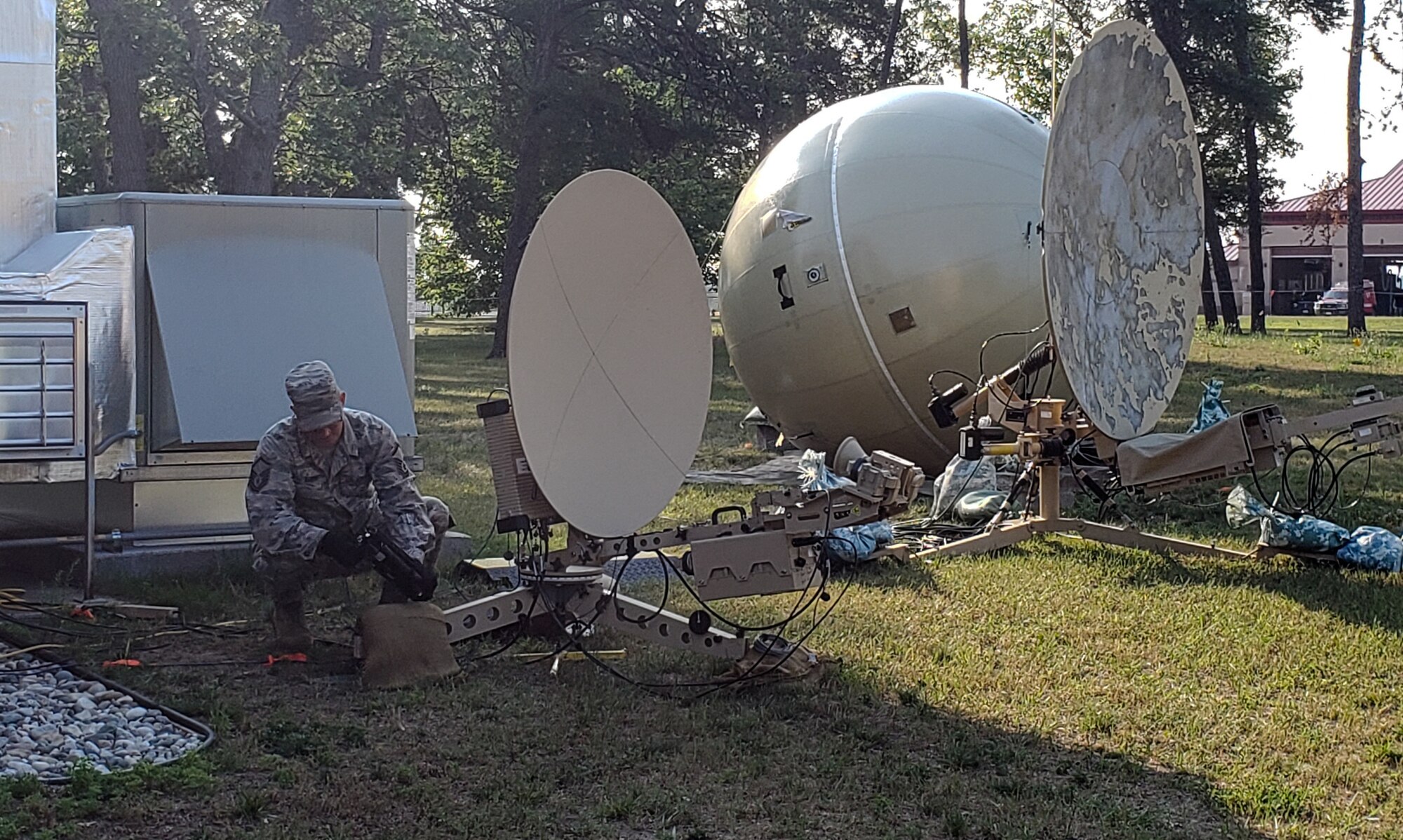 U.S. Air Force Master Sgt. Matthew Throne, a radio frequency transmission specialist with the 271st Combat Communications Squadron, Pennsylvania Air National Guard, installs a communication antenna during Operation Northern Strike July 26, 2019, at the Alpena Combat Readiness Center in Michigan.