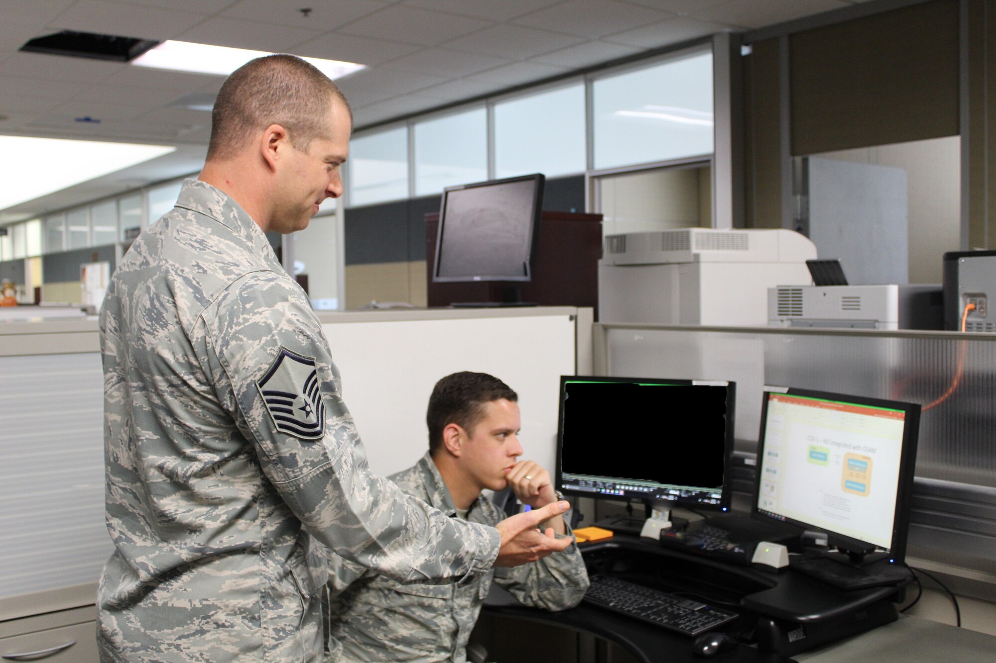 Master Sgt. David Meyers, 718th Intelligence Squadron, works with Staff Sgt. Pike Pemsteiner, 45th Intelligence Squadron, on the Gorgon Stare 2 sensor program.  Meyers was recommended to help the 45th IS with the GS 2 program because he had previous program management and training experience, to continue building the capability.