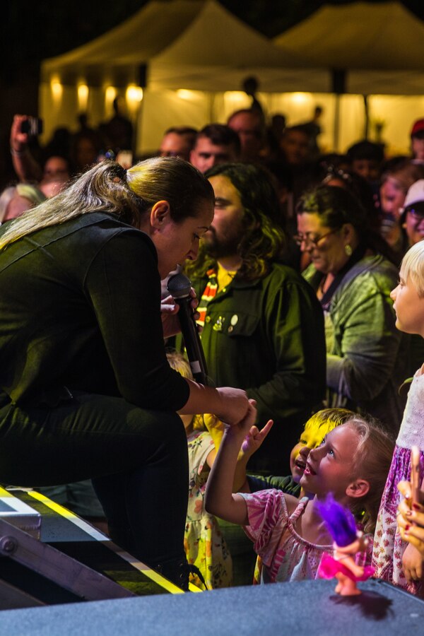 A member from the Lt. Dan Band reaches out to the crowd while performing during the Fall Carnival at the Wire Mountain softball fields on Marine Corps Base Camp Pendleton, Sept. 13, 2019. The Fall Carnival was a free event hosted by the Gary Sinise Foundation to show support for service members, and featured a concert by actor Gary Sinise and the Lt. Dan Band. (U.S. Marine Corps photo by Lance Cpl. Alison Dostie)
