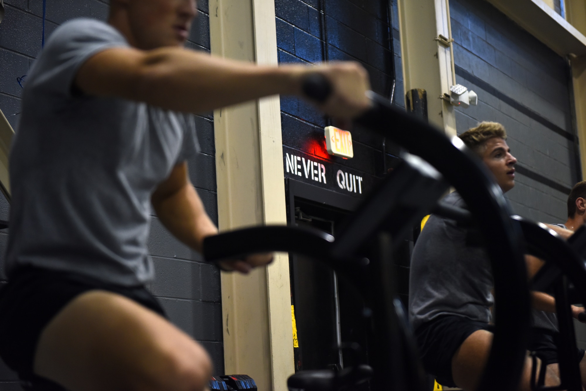Airmen from the 352nd Special Warfare Training Squadron exercise on workout bikes at Matero Hall on Keesler Air Force Base, Mississippi, Aug. 22, 2019. Special Warfare trainees partake in intense physical training sessions to prepare them for combat. (U.S. Air Force photo by Airman Seth Haddix)