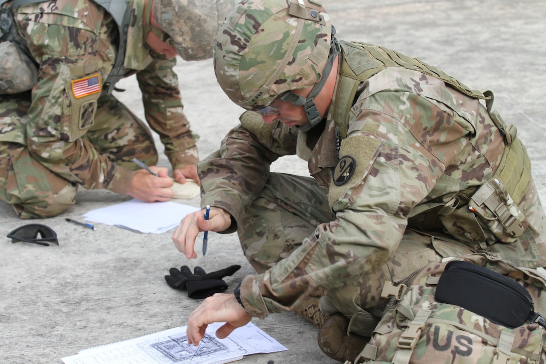 Army Reserve Soldiers of the 94th Training Division-Force Sustainment plot their points in the land navigation event at Joint Base McGuire–Dix–Lakehurst, New Jersey as part of a grueling week-long Best Warrior Competition. Competitors' mental and physical toughness was put to the test as they endured early morning and late-night events where only one competitor would claim the title for this competition.