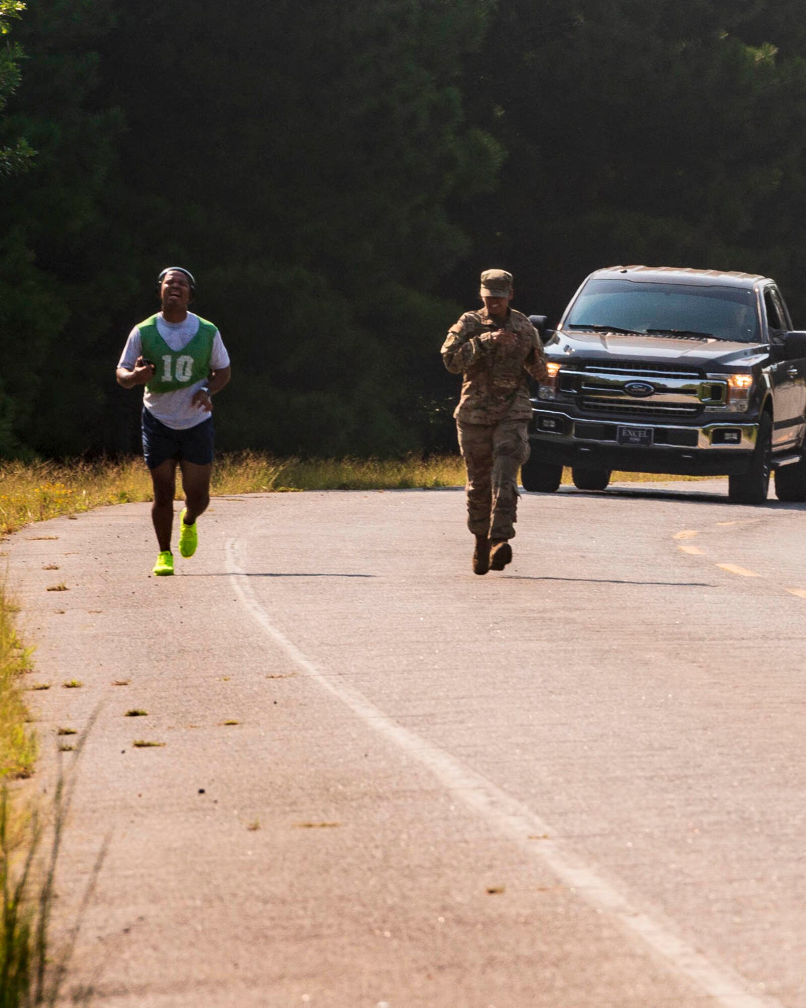 An Airman assigned to the 96th Aerial Port Squadron and a supportive wingman finishes the run portion of an official physical fitness test Sunday, Sept. 8, 2019, at Little Rock Air Force Base, Ark. Over the drill weekend, the unit fitness program manager and physical training leaders evaluated more than 100 Airmen to ensure annual readiness requirements were upheld. The Air Force Reserve’s overall readiness depends on the individual readiness of each Reserve Citizen Airman. (U.S. Air Force Reserve photo by Maj. Ashley Walker)