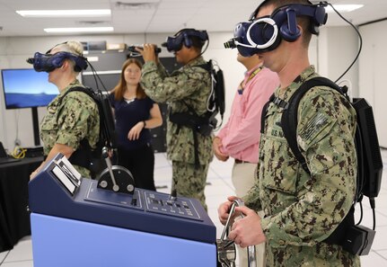 IMAGE: Naval Surface Warfare Center Dahlgren Division, Dam Neck Activity scientists and engineers assist Sailors from Tactical Training Group Atlantic during their bridge team testing of the Advanced Navigation Team Shipboard Simulation Phase 1 system in command’s Naval Simulation Center.