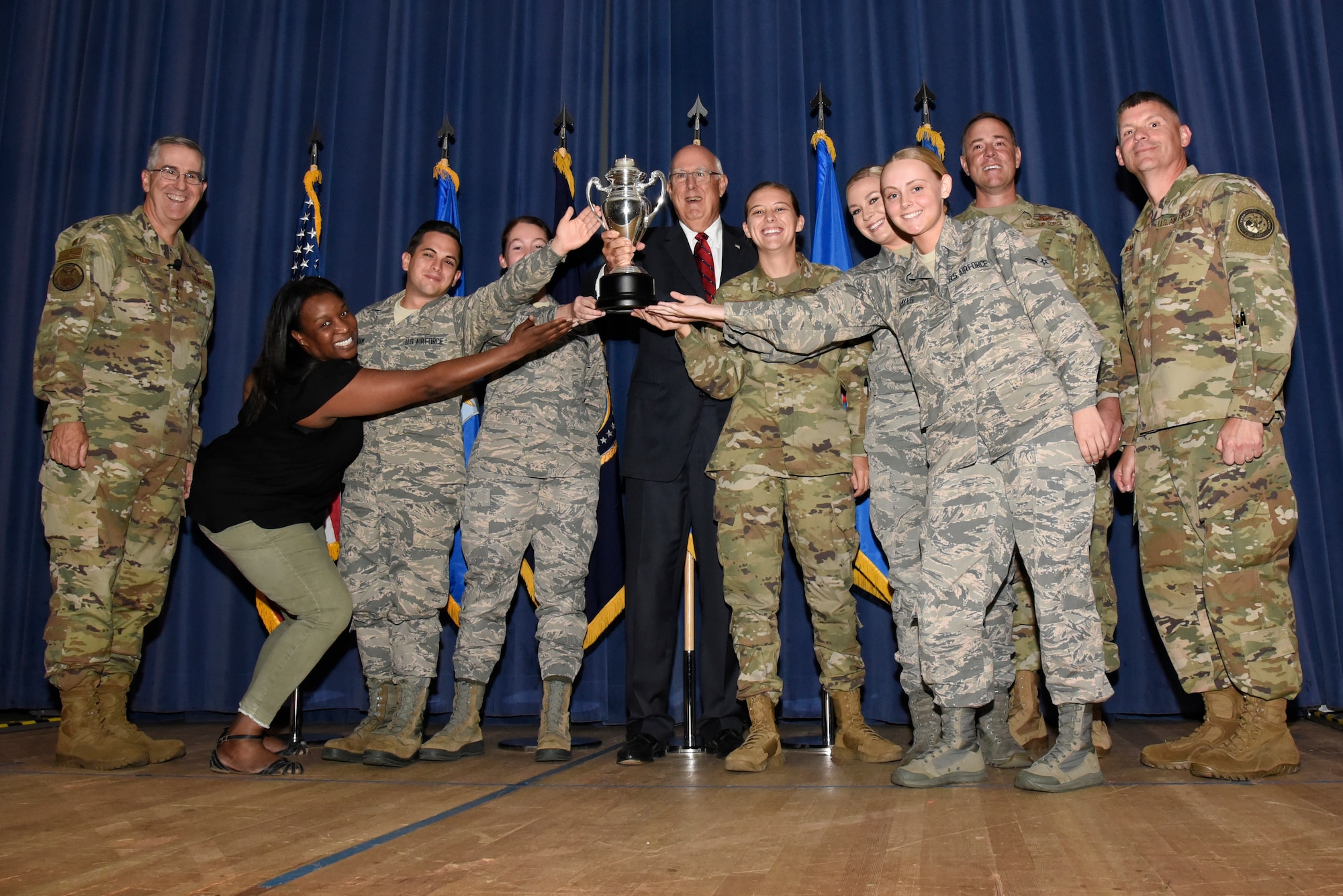 Gen. John Hyten, commander of U.S. Strategic Command, far left, Mr. Ken Stinson, chairman of Strategic Command Consultation Committee (SCC), middle, Col. Thomas Falzarano, commander of 21st Space Wing, second from right, and Chief Master Sgt. Patrick McMahon, far right, command senior enlisted leader of USSTRATCOM, present the Omaha Trophy to Airmen of the 21st Space Wing at Peterson Air Force Base, Colorado, Sept. 9, 2019. The 21st SW won the trophy for global operations, one of five official categories including intercontinental ballistic missile operations, strategic aircraft operations, strategic bomber operations and submarine ballistic missile operations. The Omaha Trophy was created by the SCC, located in Omaha, Nebraska, and presented to a unit of USSTRATCOM on behalf of the citizens of Omaha. It was first presented in 1971 and is given to the command’s best wing as a token of recognition and appreciation. (U.S. Air Force photo by Staff Sgt. Alexandra M. Longfellow)