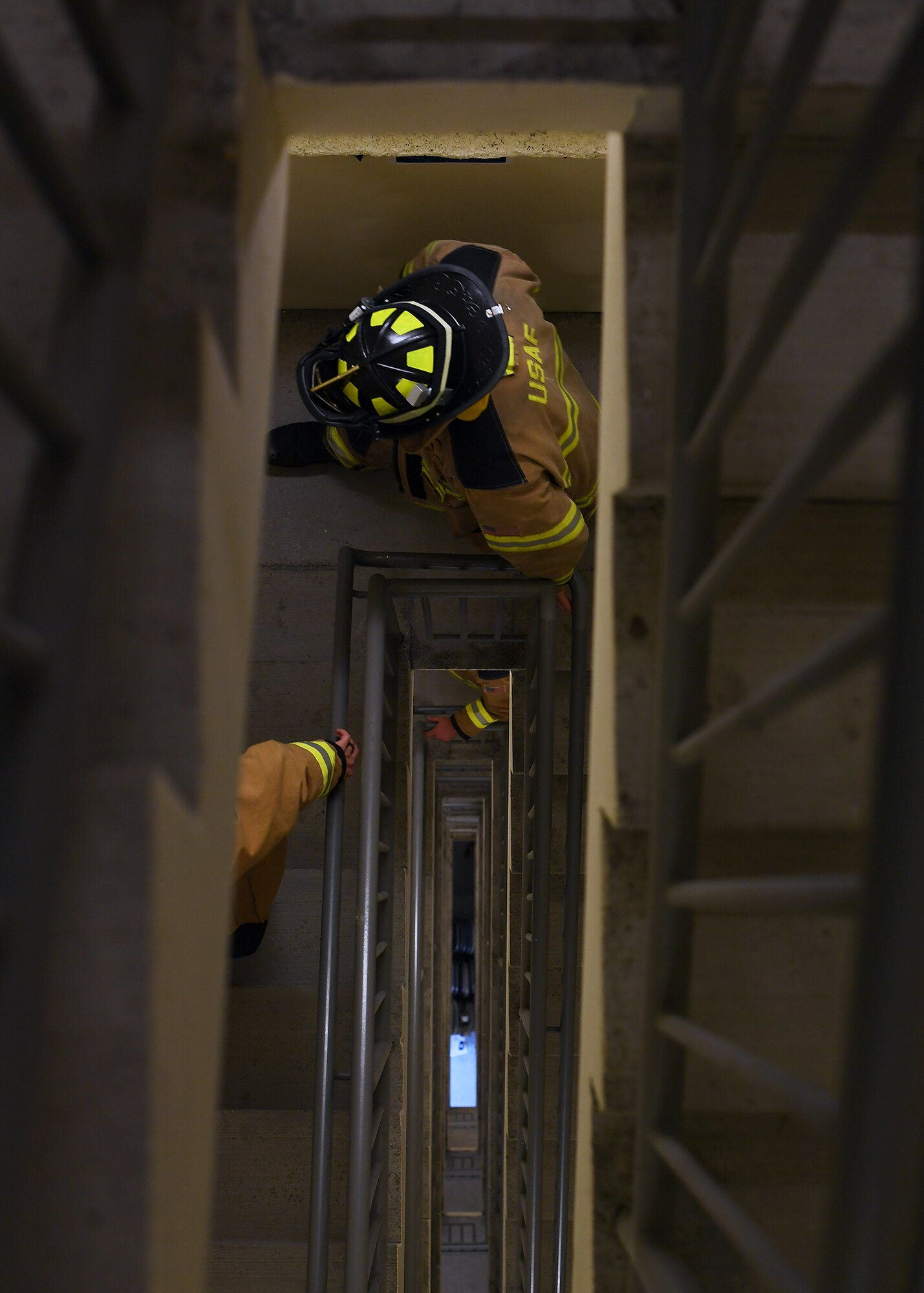 Firefighters with the 319th Civil Engineer Squadron ascend stairs during a memorial stair climb Sept.11, 2019, in the air traffic control tower on Grand Forks Air Force Base, North Dakota. The firefighters and other volunteer participants climbed the tower a total of 14 times, equating to the World Trade Center’s 110 stories. Names of victims from the 9/11 attacks were carried to the top of the tower by each climber, to be placed on a display board commemorating all who died on that day in 2001. (U.S. Air Force photo by Senior Airman Elora J. Martinez)