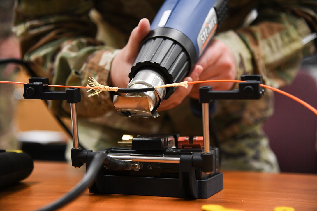 Tech. Sgt Kenan Harvey, 309th Expeditionary Depot Maintenance avionics technician, splices a fiber optic cable during a fusion splice field test at Hill Air Force Base, Utah, Sept. 10, 2019.
