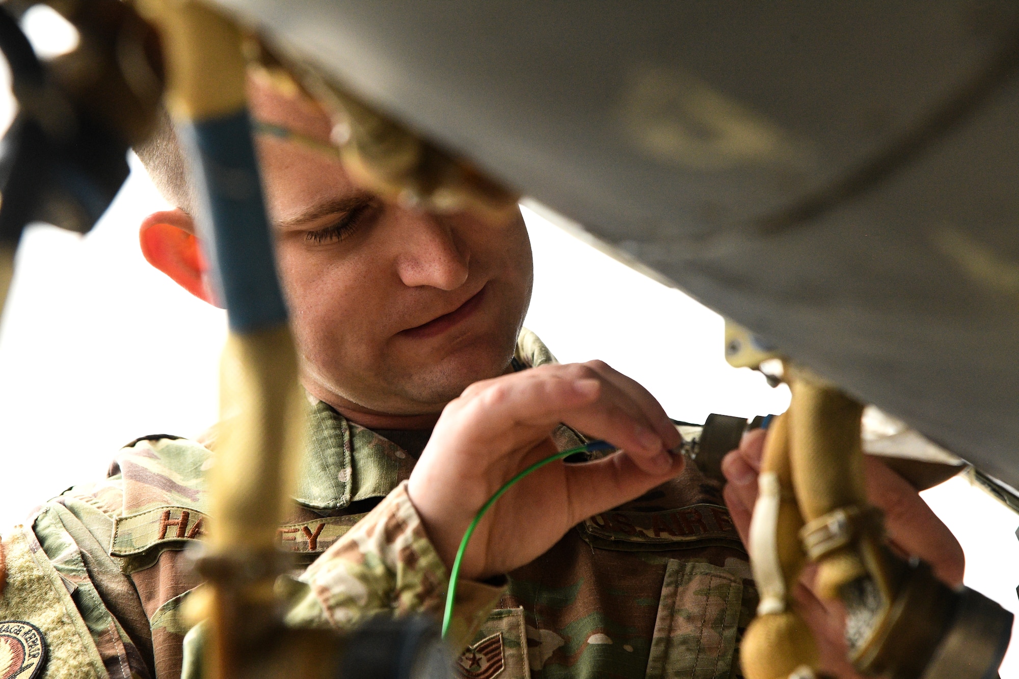 Tech. Sgt Kenan Harvey, 309th Expeditionary Depot Maintenance avionics technician, tests a fiber optic cable for signal loss at Hill Air Force Base, Utah, Sept. 11, 2019.