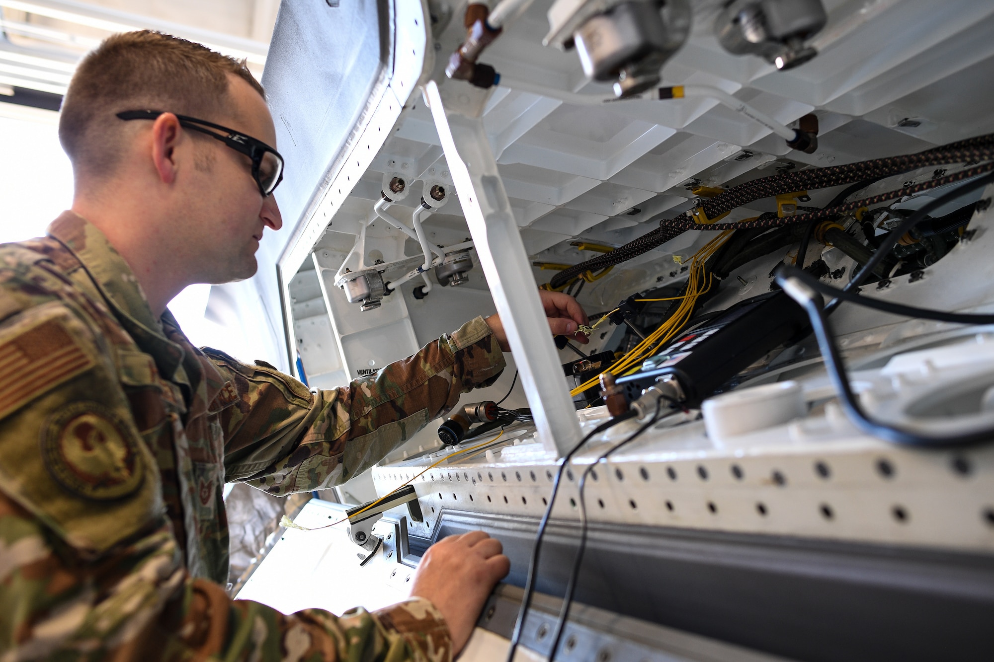 Tech. Sgt. Harvey, 309th Expeditionary Depot Maintenance avionics technician, performs a fiber optic fusion splice repair on an F-35A Lightning II at Hill Air Force Base, Utah, Sept. 12, 2019.