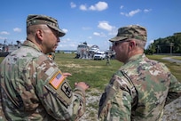 U.S. Army Col. Eric Oh, left, briefs Joint Task Force Civil Support Commanding General Maj. Gen. William “Bill” Hall following a joint mobile exercise with Assault Craft Unit FOUR. The purpose of the exercise was to increase the command’s capability to operate with the Navy to safely and efficiently deploy it’s vehicles and personnel during a catastrophic event. When directed, JTF-CS is ready to respond in 24 hours to provide command and control of 5,200 federal military forces located at more than 36 locations throughout the nation acting in support of civil authority response operations to save lives, prevent further injury, and provide critical support to enable community recover.  (U.S. Navy photo by Chief Mass Communication Specialist Barry Riley/RELEASED)