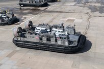 Service members from Joint Task Force Civil Support (JTF-CS) and Assault Craft Unit 4 move vehicles from Joint Expeditionary Base Little Creek-Fort Story to Fort Eustis during a mobile exercise (MOBEX) to simulate coordination and operation between the units. JTF-CS anticipates, plans, and prepares for Chemical, Biological, Radiological, and Nuclear Defense Support of Civil Authorities (CBRN-DSCA) response operations. When directed, JTF-CS deploys within 24 hours of notification to command and control DOD forces in support of civil authority response operations in order to save lives, prevent further injury, and provide temporary critical support to enable community recovery. (U.S. Navy photo by Mass Communication Specialist 2nd Class Corbin Shea/released)