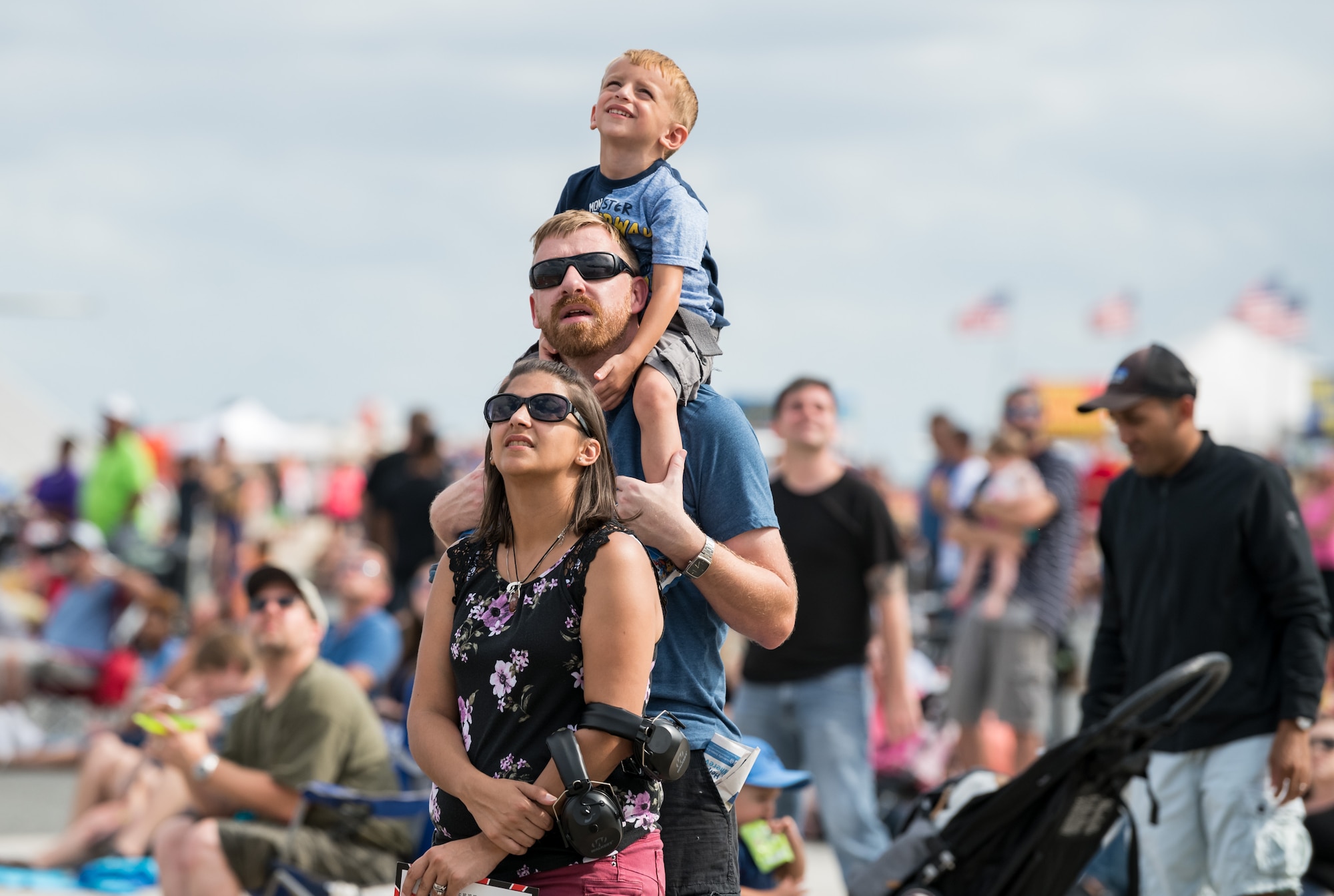 A family watches the F-22 Raptor aerial demonstration during the first day of the 2019 Thunder Over Dover Air Show Sept. 14, 2019, on Dover Air Force Base, Del. Spectators came to the base to see aerial performances and static displays and speak with local Airmen about their role in providing rapid global airlift. (U.S. Air Force photo by Roland Balik)