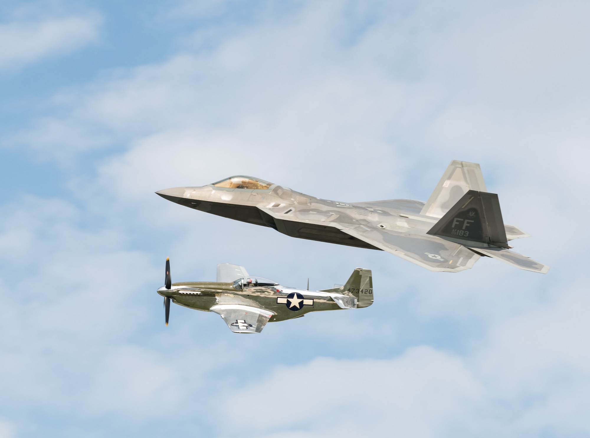 An F-22 Raptor and P-51 Mustang fly side-by-side during the heritage flight Sept. 14, 2019, at Dover Air Force Base, Del. This year's Thunder Over Dover Air Show featured more than 20 aircraft static displays, as well as numerous aerial demonstrations. (U.S. Air Force photo by Roland Balik)