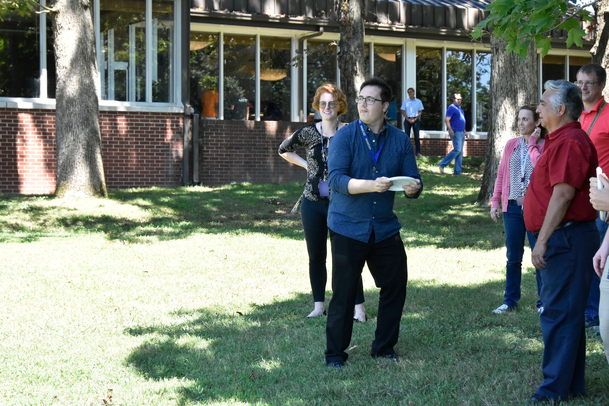 Mihai Floarea lines up a disc golf shot during the Aug. 29 “Let’s Connect” event at the Arnold Lakeside Center while Nicole Prieto, Ashley Rose-Nalin, Don Corona and Joel Nalin, from left, look on. “Let’s Connect” was a portion of the Resilience Tactical Pause at Arnold. In early August, Air Force Chief of Staff David Goldfein ordered all Air Force units to stand down for one day to focus on suicide prevention. The event at Arnold was held to comply with this directive and boost interpersonal connection among base personnel. (U.S. Air Force photo by Bradley Hicks) (This image was altered by obscuring badges for security purposes.)