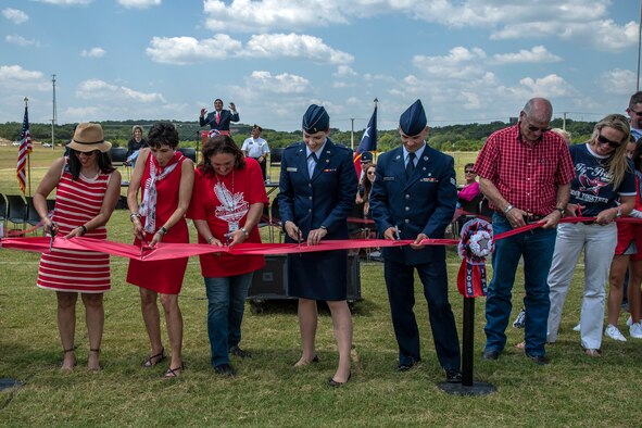 Capt. Mark T. Voss family members participate in the ribbon cutting during the Capt. Mark T. Voss Middle School dedication held in Boerne, Texas, Sept. 14, 2019. The new middle school was named in memory of Voss, who was a 2004 Boerne High School graduate. He graduated from the United States Air Force Academy in 2008 and received his wings in 2010. While in command of an Air Force KC-135 Stratotanker on a combat mission to refuel other planes over Afghanistan, a mishap brought down the plane. Voss and his two crewmates all perished in the accident May 3, 2013.