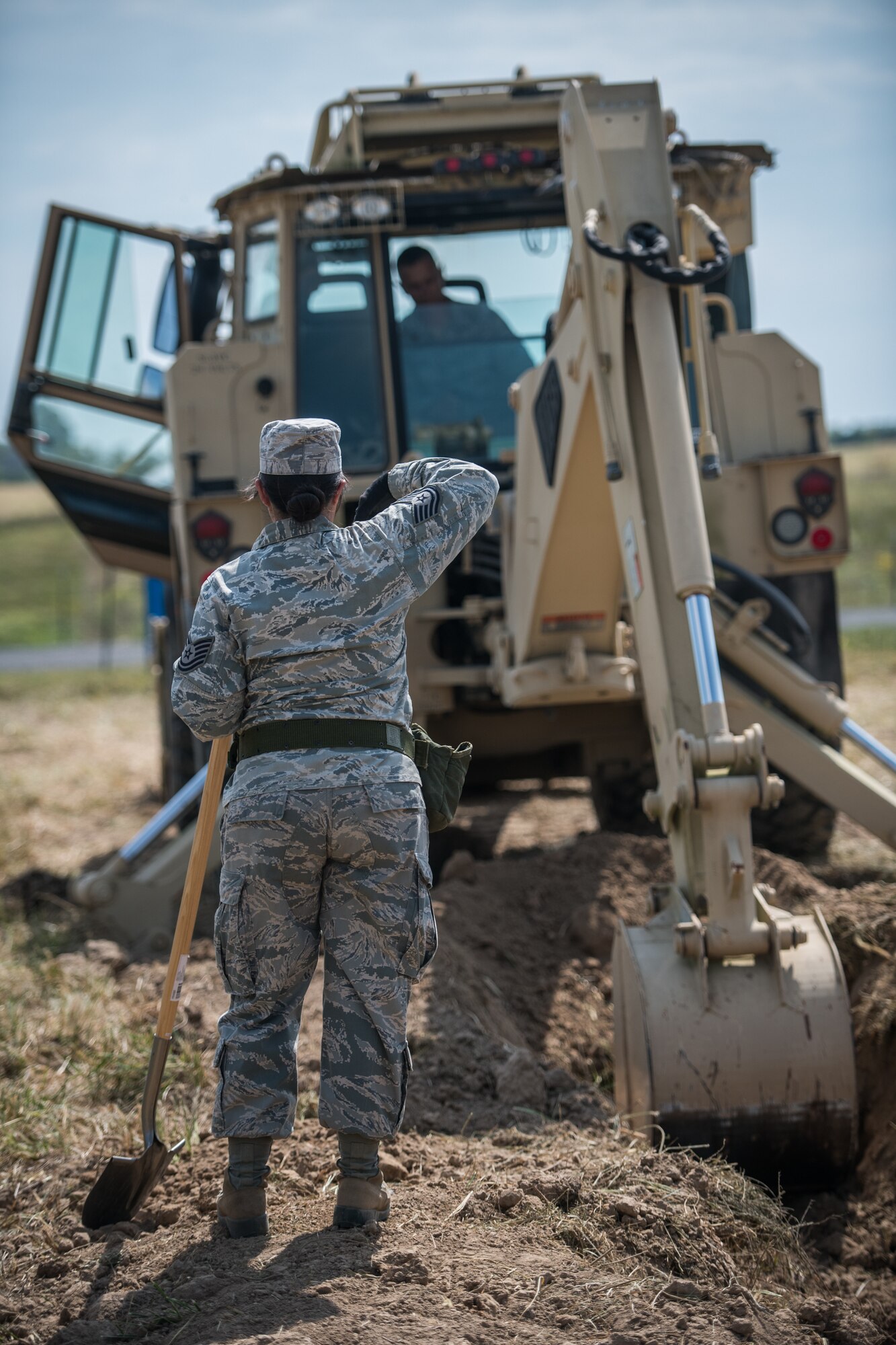U.S. Air Force Reserve Citizen Airman Tech. Sgt. Tiana Corpuz gives Tech. Sgt. Casey Goodaker, both 932nd Civil Engineer Squadron technicians, instructions on where to dig during field training, Sept. 10, 2019 at the Sparta National Guard training area, Sparta, Illinois. (U.S. Air Force photo by Master Sgt. Christopher Parr)