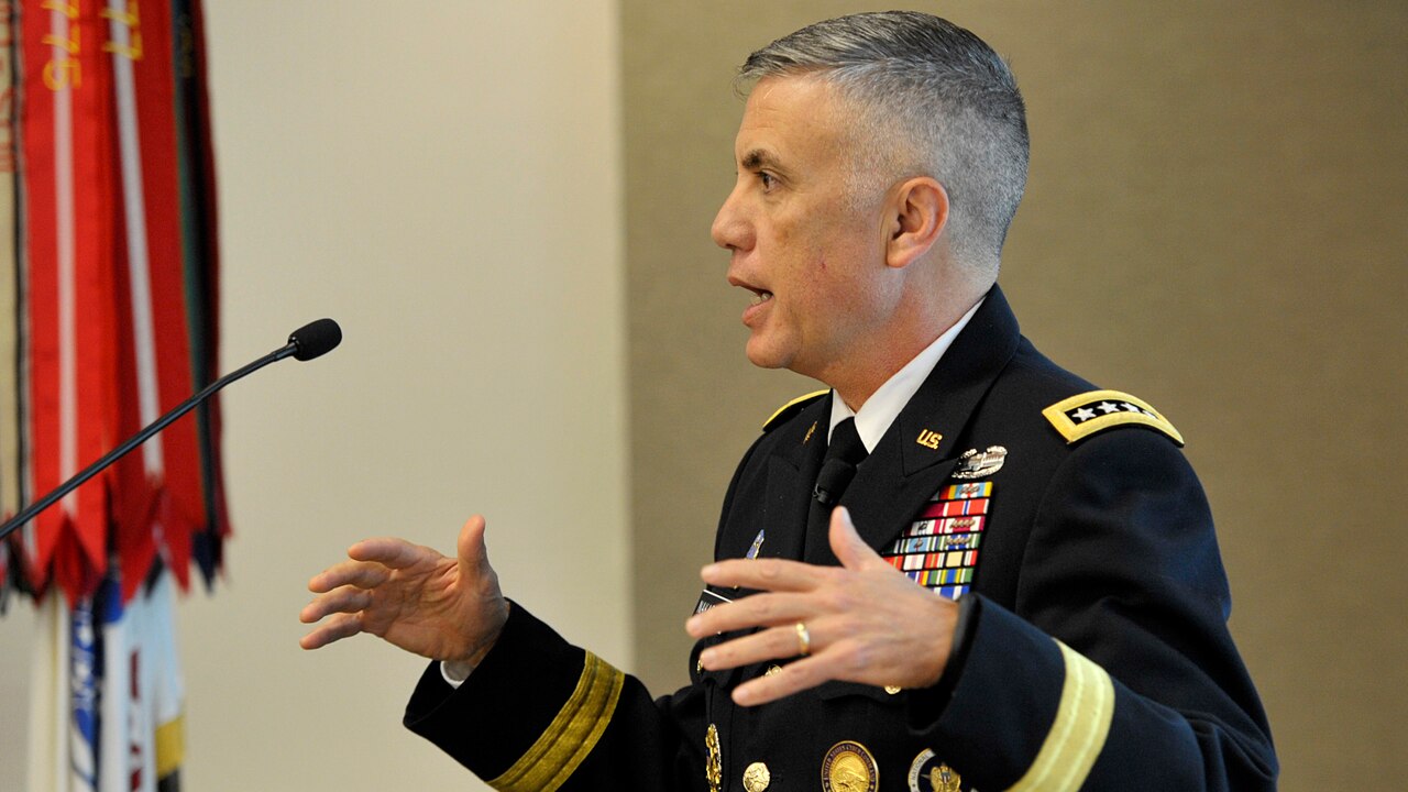 Four-star Army general speaks at lectern.