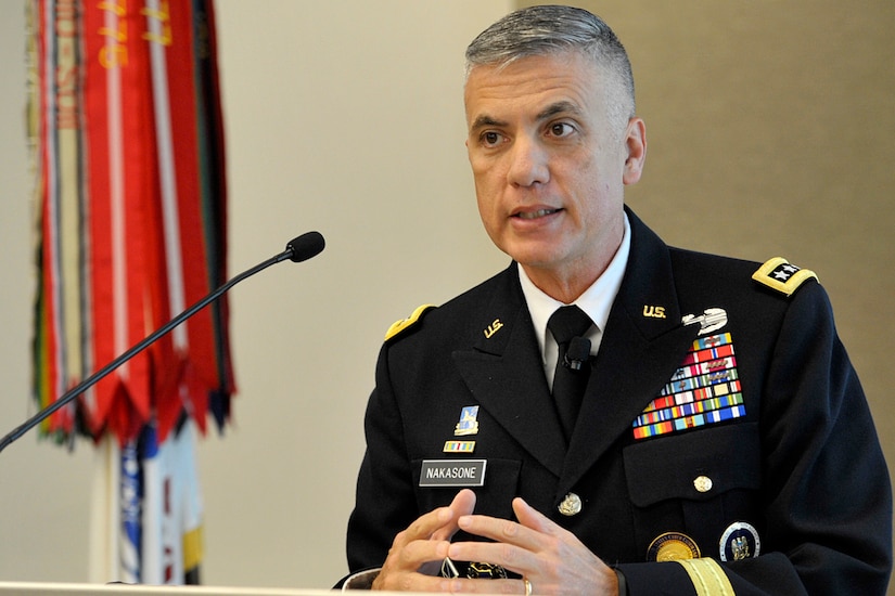 Four-star Army general speaks at lectern.