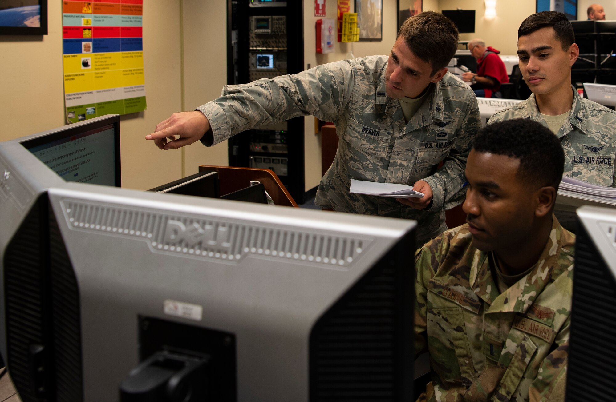 1st Lt. Brady Weaver, 4th Space Operations Squadron weapons and tactics operator, left, 1st Lt. Gary Davis, 4th SOPS wideband global SATCOM engineer, center, and 1st Lt. David Lacourrege, 4th SOPS weapons and tactics operator, run a Wideband Global SATCOM commanding operation, at Schriever Air Force Base, Colorado, Sept. 12, 2019. The 4th SOPS completed its first live on-orbit testing of three tactics, techniques and procedures on the Wideband Global SATCOM. (U.S. Air Force photo by Airman 1st Class Jonathan Whitely)