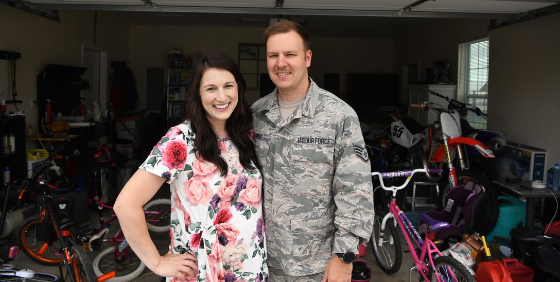 Staff Sgt. Jordan Combs, a 28th Bomb Wing administration executive support specialist, and his wife, Mallory, stand in front of their garage at Ellsworth Air Force Base, S.D., Aug. 2, 2019. The Combs’ are currently living in on-base housing and came up with the idea to make a foster ranch where they can accommodate many more children. (U.S. Air Force photo by Senior Airman Thomas Karol)