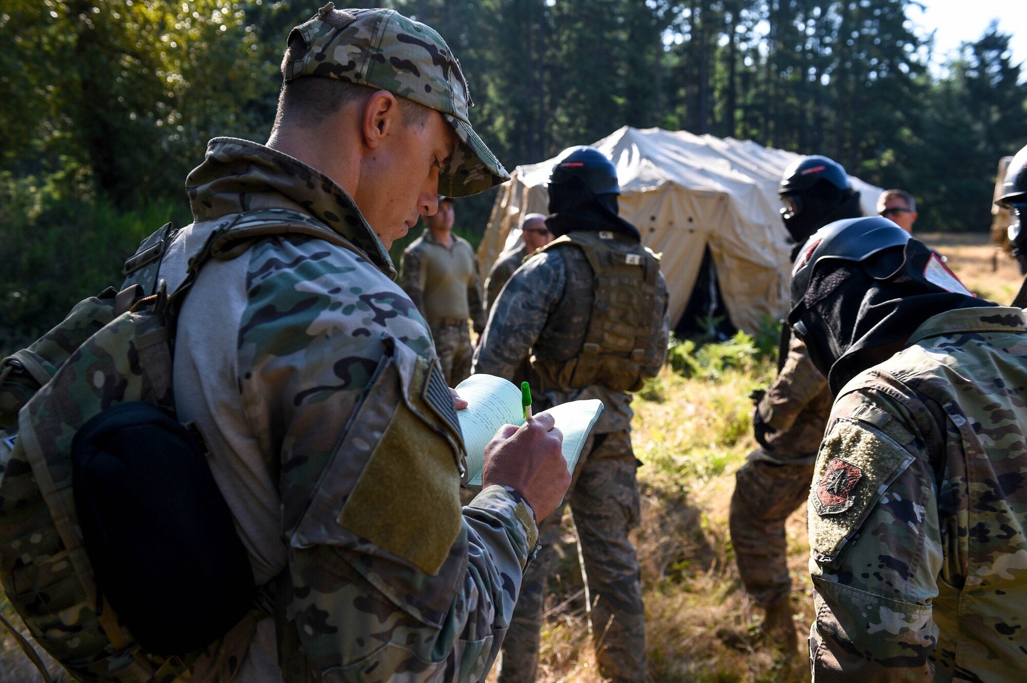 A U.S. Air Force tactical air control party (TACP) specialist assigned to the 353d Special Warfare Training Squadron, Joint Base San Antonio-Lackland, Texas, takes notes as a member of the cadre team evaluating 24 TACP officer candidates during TOPT selection course phase II, on Joint Base Lewis-McChord, Wash., Aug. 27, 2019. During this phase of selection, experienced TACP officer and enlisted cadre assess candidates throughout a week during 15 graded events that target the specific personality and character attributes that correlate with success in the TACP community.