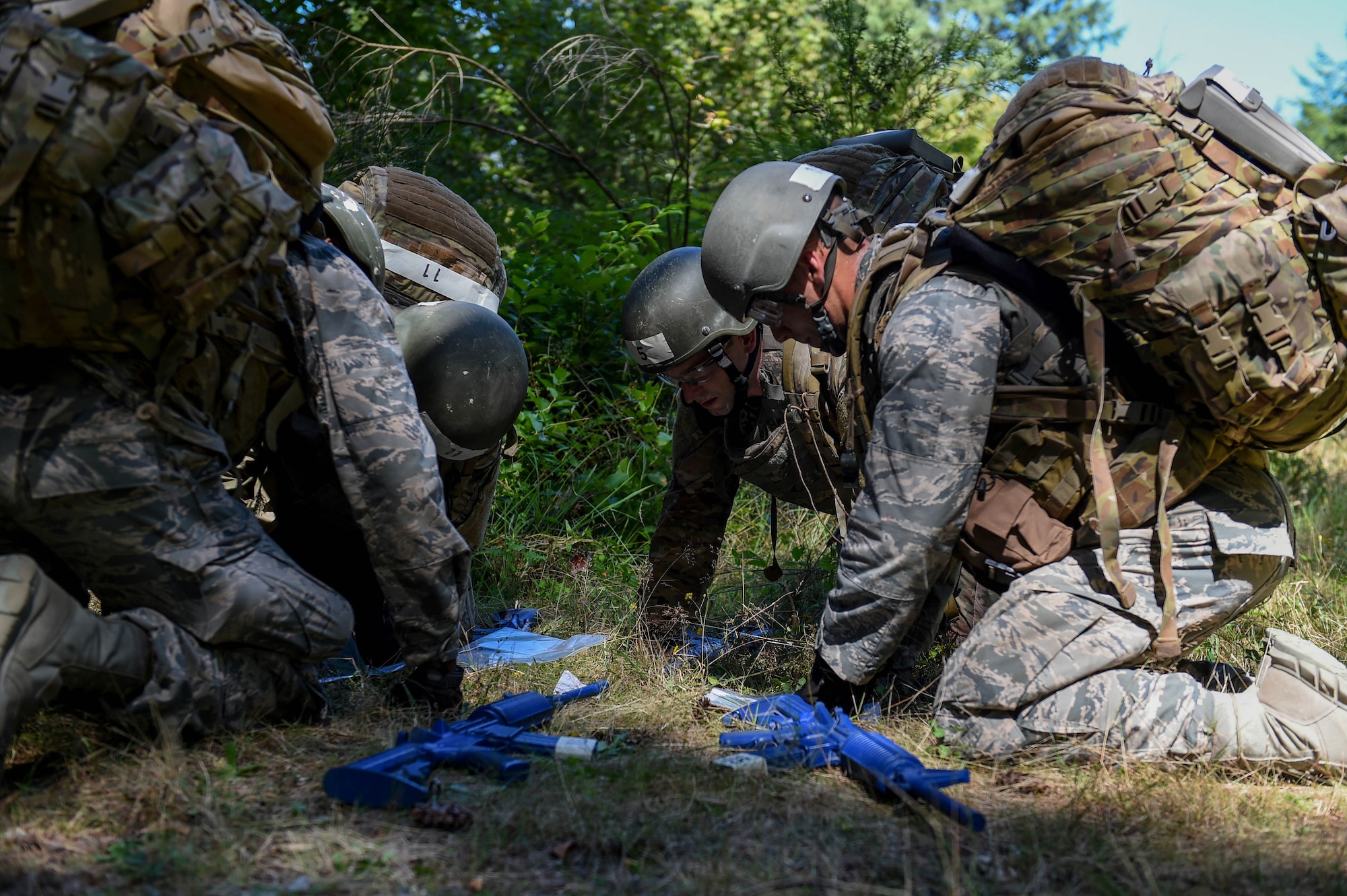 A team of tactical air control party (TACP) officer candidates examine a map of the area in preparation for a land navigation exercise on Joint Base Lewis-McChord, Wash., Aug. 27, 2019. Candidates were required to navigate to five different coordinates where a different team challenge awaited them at each new location.