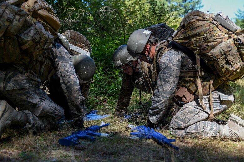 A team of tactical air control party (TACP) officer candidates examine a map of the area in preparation for a land navigation exercise on Joint Base Lewis-McChord, Wash., Aug. 27, 2019. Candidates were required to navigate to five different coordinates where a different team challenge awaited them at each new location.