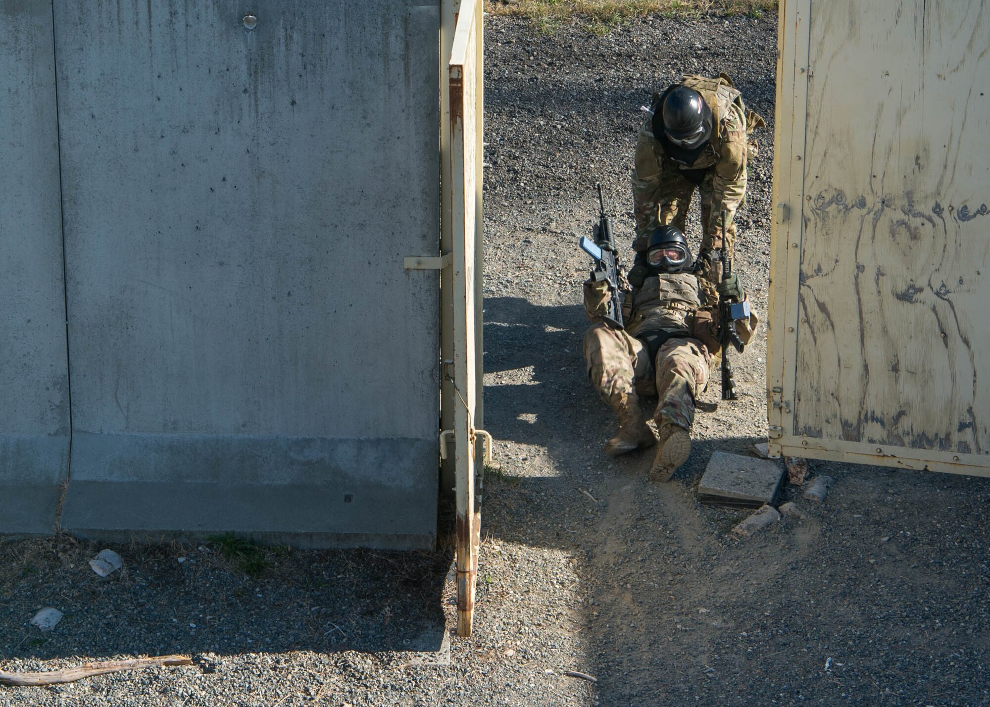 A Tactical Air Control Party (TACP) Officer Phase Two (TOPT) assessment candidate drags a simulated injured team member out of a tactical village during hands-on training at Joint Base Lewis-McChord, Aug. 27, 2019. . The simulated combat environments and stressful situations created during TOPT allows the cadre to understand how each candidate behaves and performs under pressure to ensure they are well suited for future operational roles as a TACP officer.