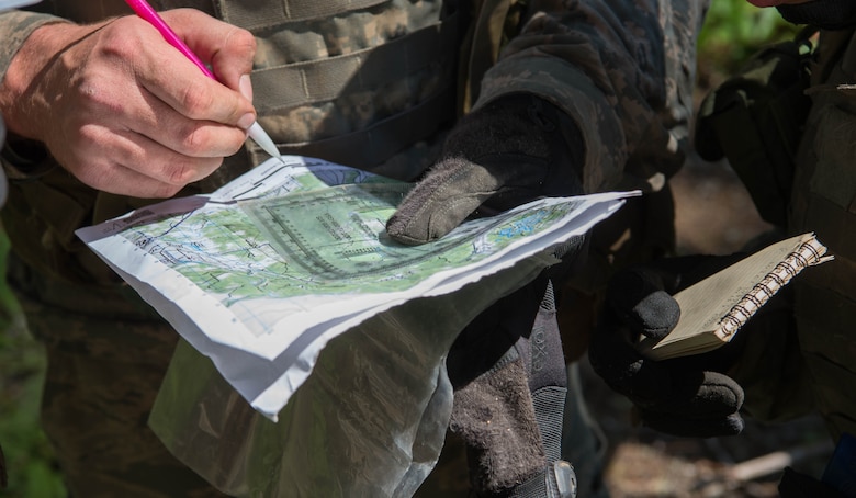 Tactical Air Control Party (TACP) Officer Phase Two (TOPT) assessment candidates plot the course to their next location to test their survival skills at Joint Base Lewis-McChord, Aug. 27, 2019. The TOPT 5-day assessment is designed primarily to create situations that allow candidates the opportunity to demonstrate their aptitude to lead in a stressful environment.
