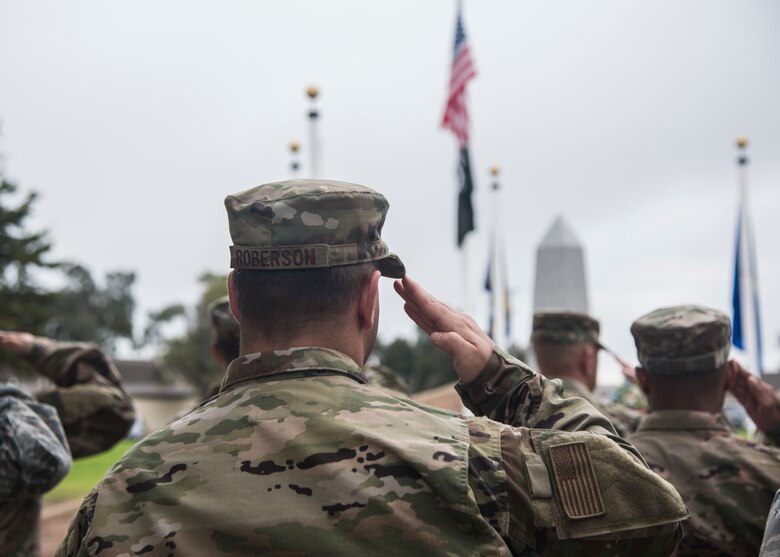 Service members render a salute during the playing of taps at the POW/MIA Opening Ceremony Sept. 16, 2019, at Vandenberg Air Force Base, Calif.