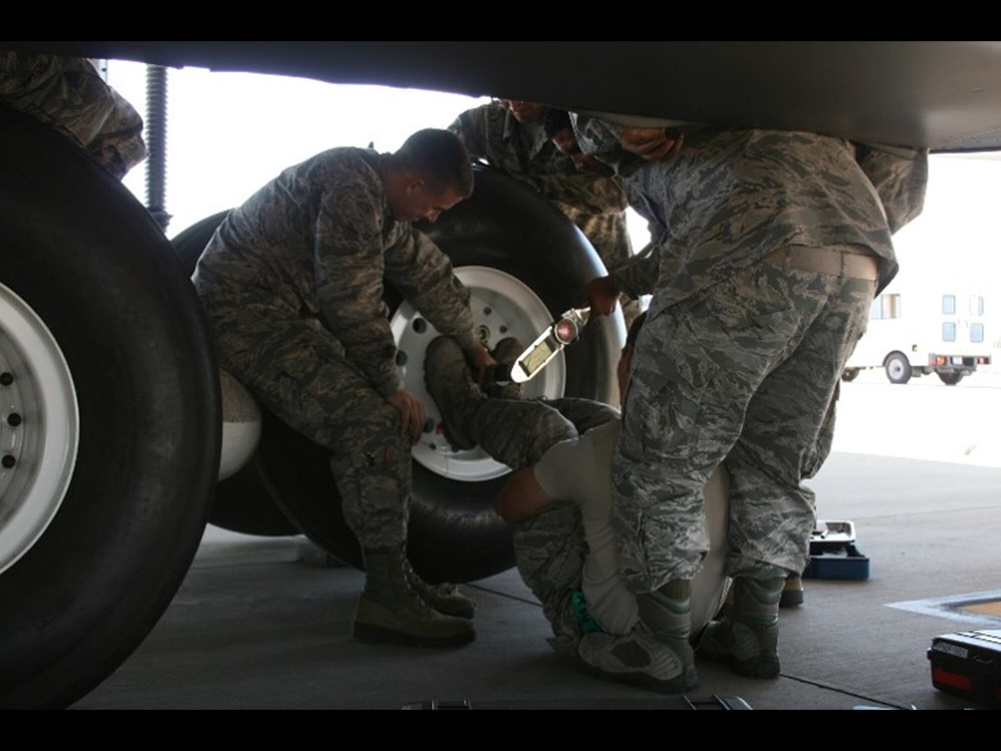 Current C-5 cargo airplane tire replacement requires up to five Airmen with a multitude of tools to replace a tire. The Air Force Research Laboratory Junior Force Warfighter Operations Team works on a solution for this awkward and uncomfortable task.(U.S. Air Force photo)