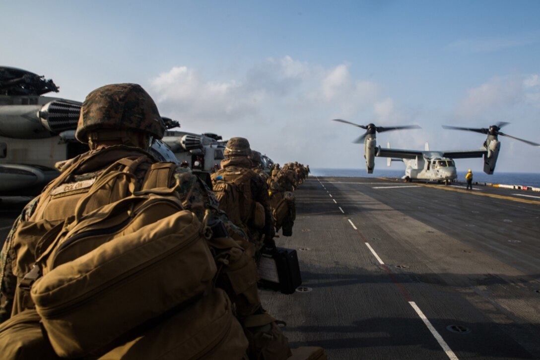 Marines with Echo Company, Battalion Landing Team, 2nd Battalion, 1st Marines, 31st Marine Expeditionary Unit, load onto an MV-22B Osprey tiltrotor aircraft prior to a simulated airfield seizure as part of a long-range raid from the amphibious assault ship USS Wasp (LHD 1), Philippine Sea, Aug. 12, 2019. The 31st MEU and Amphibious Squadron 11, aboard Wasp Amphibious Ready Group ships, conducted a series of sequential operations which simulated naval expeditionary combined-arms maneuver from amphibious assets to shore, utilizing Marine Air-Ground Task Force capabilities integrated across all warfighting domains. (U.S. Marine Corps photo by Lance Cpl. Kenny Nunez Bigay)