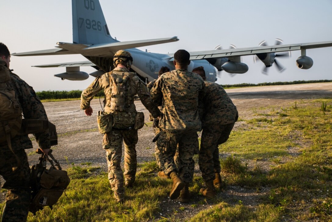 Marines with Echo Company, Battalion Landing Team, 2nd Battalion, 1st Marines, 31st Marine Expeditionary Unit, carry a simulated casualty to a KC-130 during a simulated airfield seizure after a long-range raid from the amphibious assault ship USS Wasp (LHD 1) at Ie Shima Training Facility, Okinawa, Japan, Aug. 13, 2019. The 31st MEU and Amphibious Squadron 11, aboard Wasp Amphibious Ready Group ships, conducted a series of sequential operations which simulated naval expeditionary combined-arms maneuver from amphibious assets to shore, utilizing Marine Air-Ground Task Force capabilities integrated across all warfighting domains. (U.S. Marine Corps photo by Lance Cpl. Kenny Nunez Bigay)