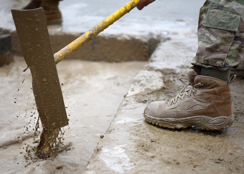 An Airman from the 51st Civil Engineer Squadron mixes a layer of specialized concrete during the 51st CES’ biannual rapid airfield damage repair training on Osan Air Base, Republic of Korea, September 12, 2019. When repairing a damaged airfield, there are two layers of concrete that need to be leveled and set in order for the airfield to be back to mission ready. (U.S. Air Force photo by Senior Airman Denise M. Jenson)